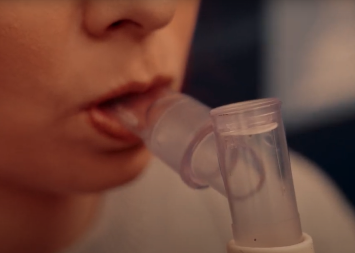 Close-up of woman breathing through mouthpiece for a metabolic test